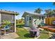 Green backyard featuring a screened patio and a shed, offering a blend of indoor-outdoor living at 11296 90Th Ave, Seminole, FL 33772