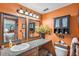 This bathroom features double mirrors, a granite countertop and cabinet storage at 11296 90Th Ave, Seminole, FL 33772