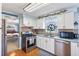 Kitchen area featuring stainless steel appliances and white cabinetry at 11296 90Th Ave, Seminole, FL 33772
