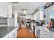 Open kitchen featuring white cabinets, stainless steel appliances, and hardwood floors at 11296 90Th Ave, Seminole, FL 33772
