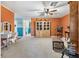 Open living room with a large cabinet, neutral carpet, and a view of other rooms at 11296 90Th Ave, Seminole, FL 33772