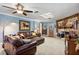 Spacious living room features a stone fireplace and plush leather seating at 11296 90Th Ave, Seminole, FL 33772