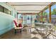Enclosed patio featuring a table with chairs, offering a cozy outdoor living space at 11296 90Th Ave, Seminole, FL 33772