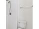 Bathroom featuring a shower head and white tile surround plus a toilet at 11627 Ivy Flower Loop, Riverview, FL 33578