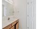 Bathroom featuring a white countertop, wood cabinets, sink, and a large mirror at 11627 Ivy Flower Loop, Riverview, FL 33578