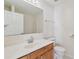 Well lit bathroom features a sink and vanity, with a framed mirror, toilet and a shower at 11627 Ivy Flower Loop, Riverview, FL 33578