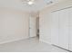 Bedroom featuring tiled floor, ceiling fan, closet, and access to a hallway at 11627 Ivy Flower Loop, Riverview, FL 33578