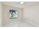 Bedroom featuring tiled floor, a ceiling fan, and a window with views at 11627 Ivy Flower Loop, Riverview, FL 33578