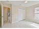 Bedroom with tiled floor, ceiling fan, closet, and access to a hallway at 11627 Ivy Flower Loop, Riverview, FL 33578