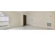 Inviting living room featuring a dark wooden entry door and bright white tile flooring at 11627 Ivy Flower Loop, Riverview, FL 33578