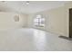 Expansive living area with bright tile flooring and an arched doorway at 11627 Ivy Flower Loop, Riverview, FL 33578