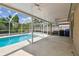 Outdoor retreat with a refreshing screened-in pool, covered patio, ceiling fans and blue trash cans at 11627 Ivy Flower Loop, Riverview, FL 33578