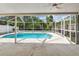 Enjoy the screened-in pool area surrounded by lush greenery and offering a relaxing outdoor retreat at 11627 Ivy Flower Loop, Riverview, FL 33578
