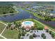 Aerial view of community center with pool, playground, parking, and beautiful surrounding lakes and walking paths at 11904 Greenchop Pl, Riverview, FL 33579