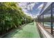 Backyard batting cage featuring artificial turf and netting, perfect for baseball or softball practice at 11904 Greenchop Pl, Riverview, FL 33579