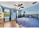 Blue bedroom featuring hardwood floors, a window with natural light, and a bed with a baseball theme at 11904 Greenchop Pl, Riverview, FL 33579