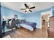 Bright bedroom with hardwood floors, blue walls, and a bed featuring a baseball theme at 11904 Greenchop Pl, Riverview, FL 33579