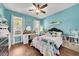 Well lit bedroom with wood floors, desk, and furniture at 11904 Greenchop Pl, Riverview, FL 33579