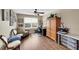 Cozy home office features a ceiling fan, large window, wood floors, craft storage, and comfortable seating area at 11904 Greenchop Pl, Riverview, FL 33579