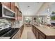 Spacious kitchen with stainless steel appliances, granite counters, and open to the living area at 11904 Greenchop Pl, Riverview, FL 33579