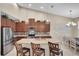 Open kitchen with stainless steel appliances, granite counters, and a center island with seating at 11904 Greenchop Pl, Riverview, FL 33579