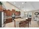 Well-lit kitchen featuring granite countertops, stainless steel appliances, and a cozy breakfast bar at 11904 Greenchop Pl, Riverview, FL 33579