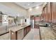 Bright, spacious kitchen with granite countertops, stainless steel appliances, and dark wood cabinetry at 11904 Greenchop Pl, Riverview, FL 33579