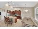 Bright kitchen with granite counters, stainless steel appliances, dark wood cabinets, and adjacent dining area at 11904 Greenchop Pl, Riverview, FL 33579