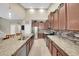 Contemporary kitchen with granite countertops, stainless steel appliances, and ceramic tile backsplash at 11904 Greenchop Pl, Riverview, FL 33579