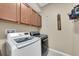 Convenient laundry room featuring top-of-the-line washer and dryer and custom cabinetry for storage at 11904 Greenchop Pl, Riverview, FL 33579