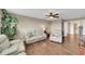 Comfortable living room features hardwood floors, ceiling fan, cozy seating area, and a glimpse of the bathroom at 11904 Greenchop Pl, Riverview, FL 33579
