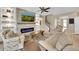 A cozy living room features a modern electric fireplace, built-in shelving, and comfortable seating at 11904 Greenchop Pl, Riverview, FL 33579