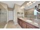 Beautiful bathroom featuring double sinks with granite counters and a glass enclosed shower at 11904 Greenchop Pl, Riverview, FL 33579