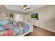 Spacious main bedroom featuring wood floors, a ceiling fan, and an en-suite bathroom at 11904 Greenchop Pl, Riverview, FL 33579