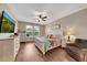 Comfortable bedroom featuring wood floor and windows that let in a lot of natural light at 11904 Greenchop Pl, Riverview, FL 33579