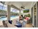 Relaxing screened patio area features an outdoor television, seating area, and access to the pool at 11904 Greenchop Pl, Riverview, FL 33579