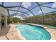 Inviting screened-in pool with clear blue water, sun loungers, and an outdoor dining set at 11904 Greenchop Pl, Riverview, FL 33579