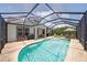 View of pool, screened lanai, and backyard at 11904 Greenchop Pl, Riverview, FL 33579