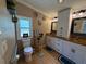 Bathroom featuring double vanities, neutral walls, decorative accents and a toilet at 12021 Club House Rd, Brooksville, FL 34613