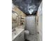 Decorated bathroom featuring a patterned ceiling, single vanity, toilet and shower stall at 12021 Club House Rd, Brooksville, FL 34613