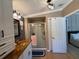 This bathroom features a glass-enclosed shower, wood-style flooring, and modern lighting fixtures at 12021 Club House Rd, Brooksville, FL 34613