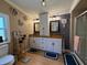Bathroom featuring double vanities, neutral walls, decorative accents and a shower stall at 12021 Club House Rd, Brooksville, FL 34613