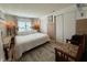 Bright bedroom featuring a large bed with crisp white linens and window views at 12021 Club House Rd, Brooksville, FL 34613