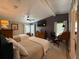 Spacious bedroom with two beds, dark wooden furniture, and a large mounted television at 12021 Club House Rd, Brooksville, FL 34613