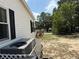 Home exterior with neutral siding, dark shutters, and well-kept landscaping at 12021 Club House Rd, Brooksville, FL 34613