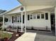 Detailed front exterior showcasing decorative windows, siding, and manicured landscaping at 12021 Club House Rd, Brooksville, FL 34613