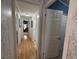 Hallway with nice wallpaper and access to various rooms in the house at 12021 Club House Rd, Brooksville, FL 34613