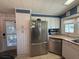 Bright kitchen with stainless steel appliances, updated cabinetry, and convenient access to the porch at 12021 Club House Rd, Brooksville, FL 34613
