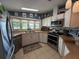 Cozy kitchen featuring stainless steel appliances, bright window views, and ample counter space at 12021 Club House Rd, Brooksville, FL 34613