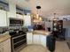 Modern kitchen featuring stainless steel appliances, breakfast bar, and open layout to living area at 12021 Club House Rd, Brooksville, FL 34613